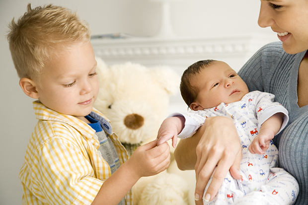 A mother and her son with a new baby