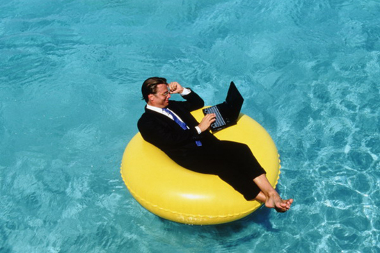 Businessman using laptop float on - Aruba